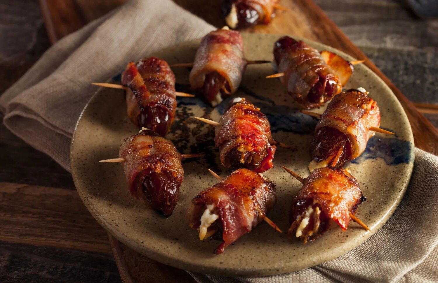 Bacon-wrapped Medjool dates on a plate