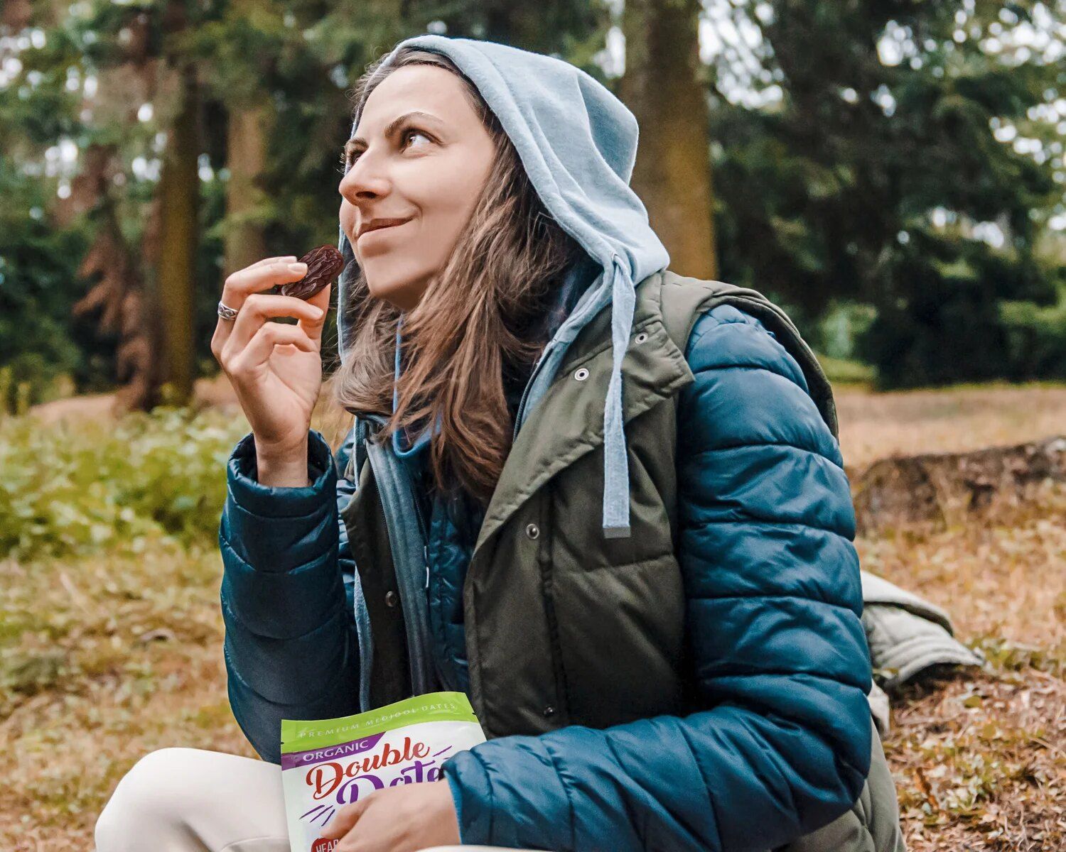 Hiker snacking on a Medjool date in the forest